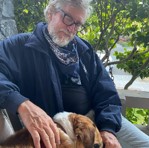 Photo of Larry with a dog.